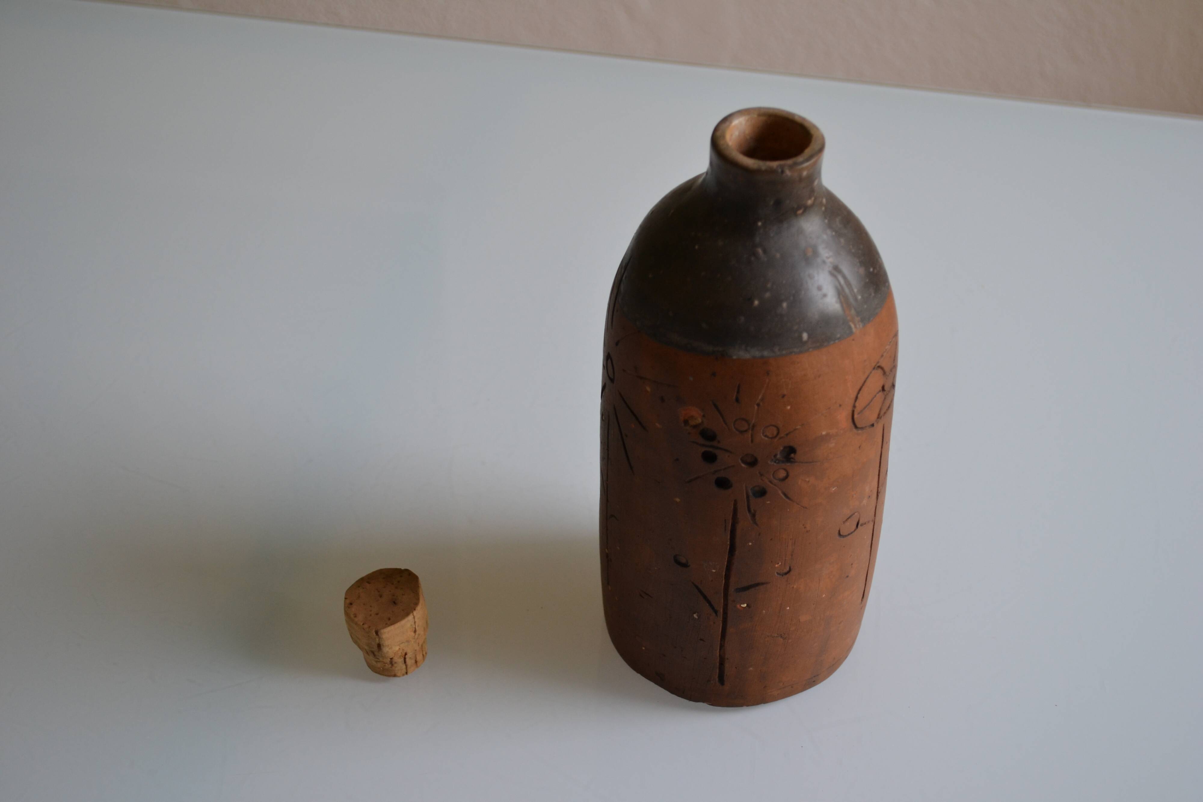 Bottle vase decorative flowers ceramic signature with fish to identify.