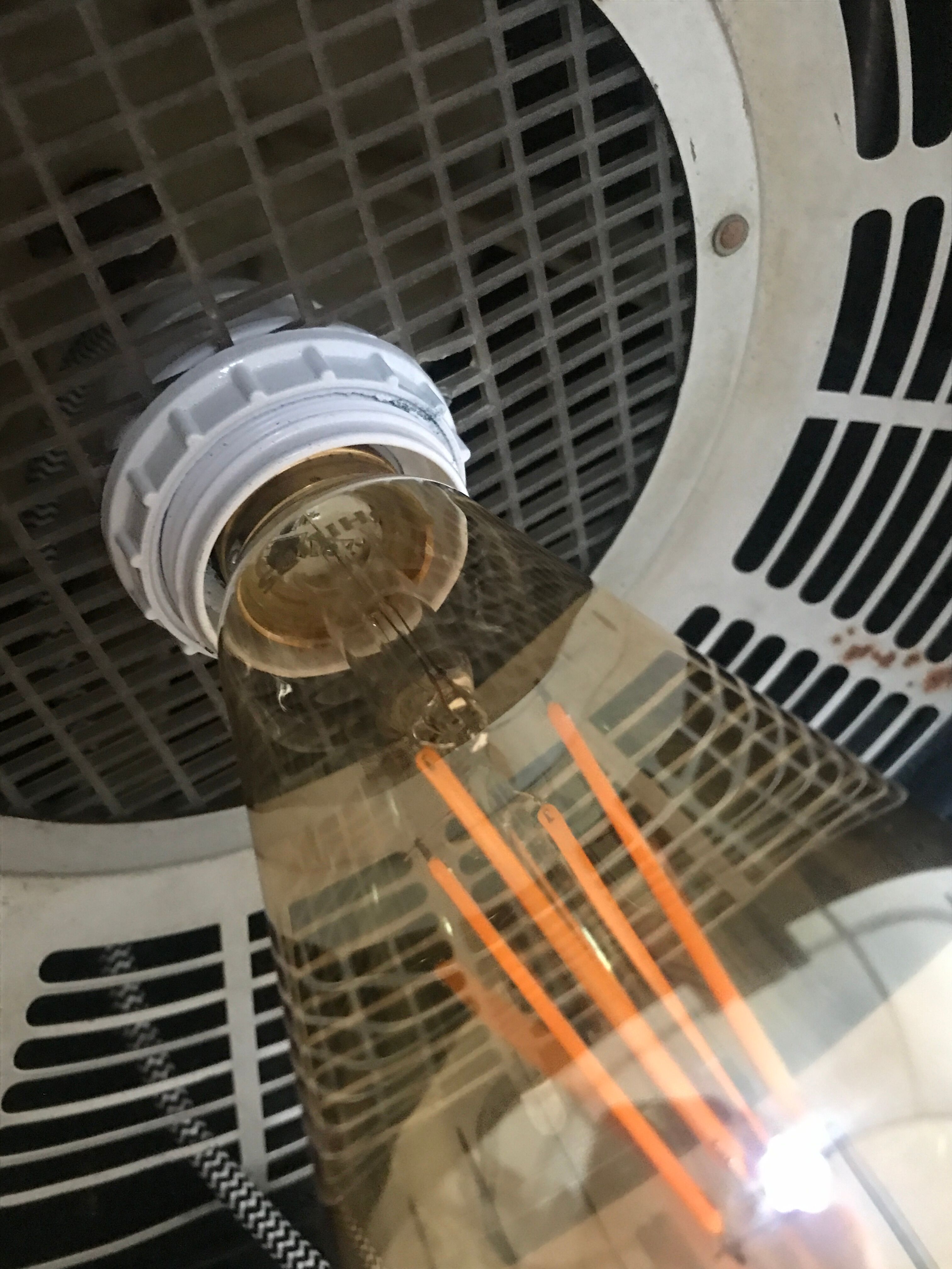 Vintage hairdresser's armchair with helmet transformed into a lamp