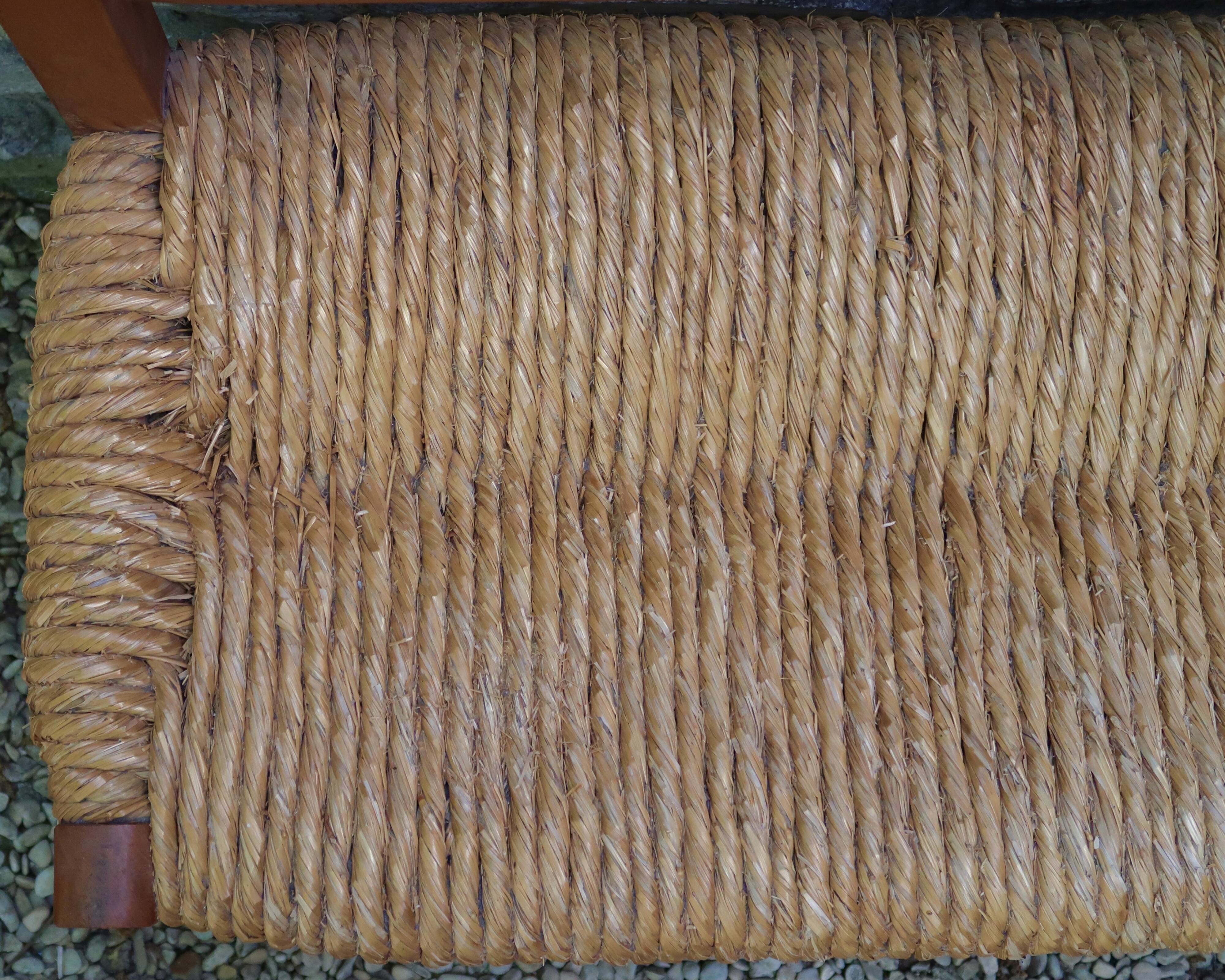 Wooden-backed bench with straw seat, 1970s.
