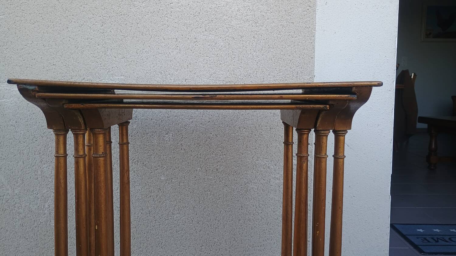 Sets of three nesting tables with painted landscape decorations in poplar.