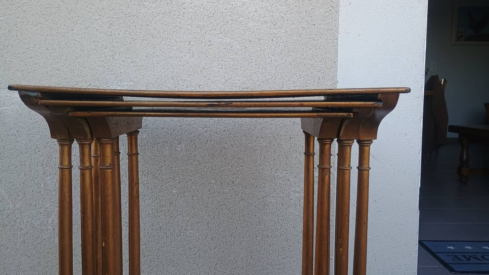 Sets of three nesting tables with painted landscape decorations in poplar.