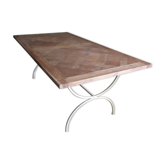 Dining table with painted iron base and parquet oak top