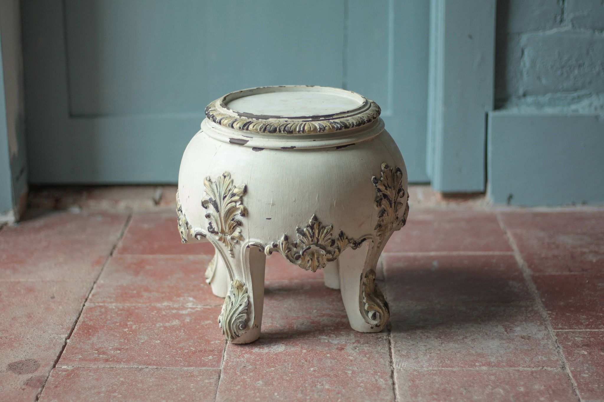 Solid wood plant stand with Louis XV style palm leaf motifs.