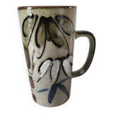 Glazed stoneware mug with free decoration, vintage pottery work.