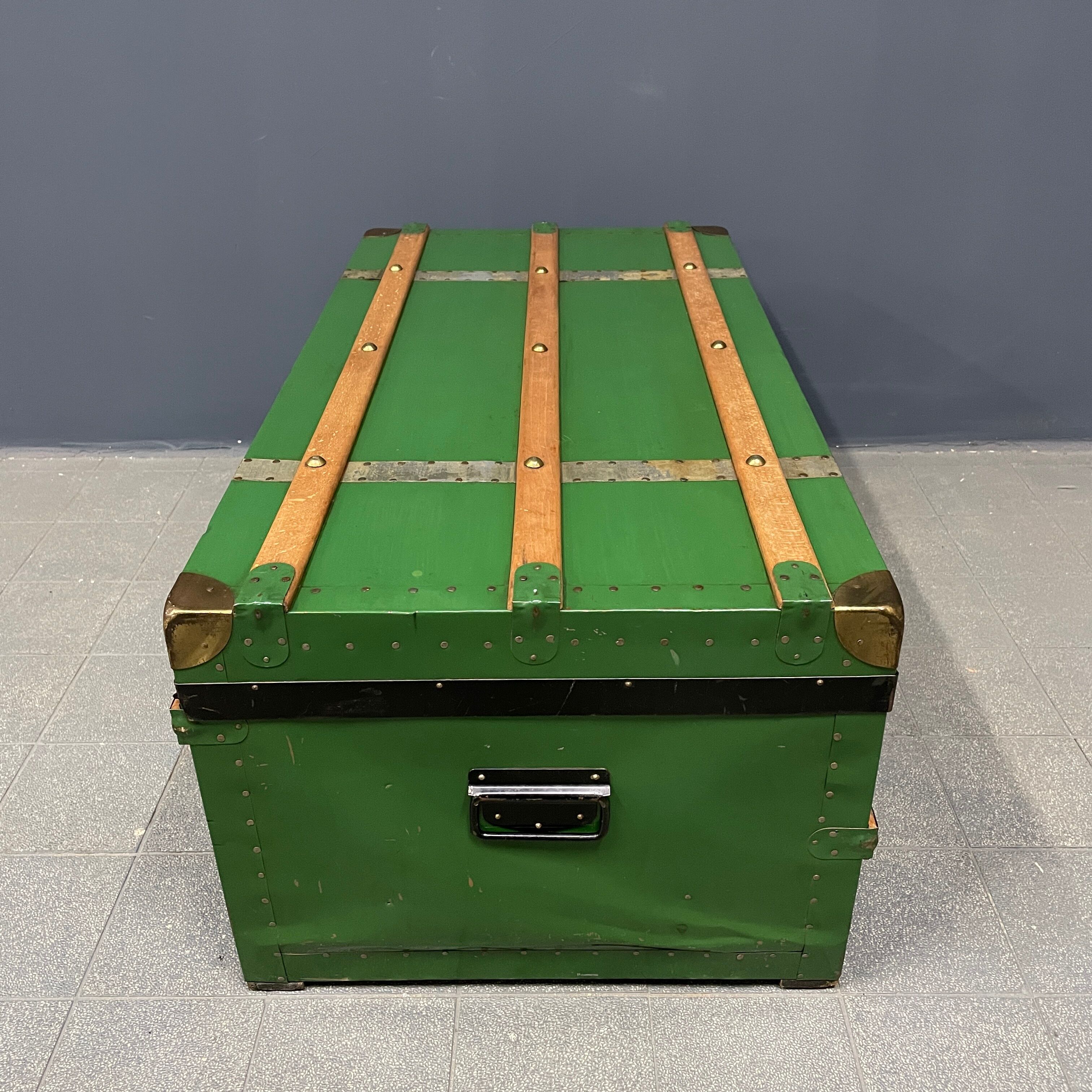 Green metal trunk with wooden sleds