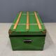 Green metal trunk with wooden sleds
