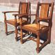 Pair of oak armchairs with straw seats and backs.