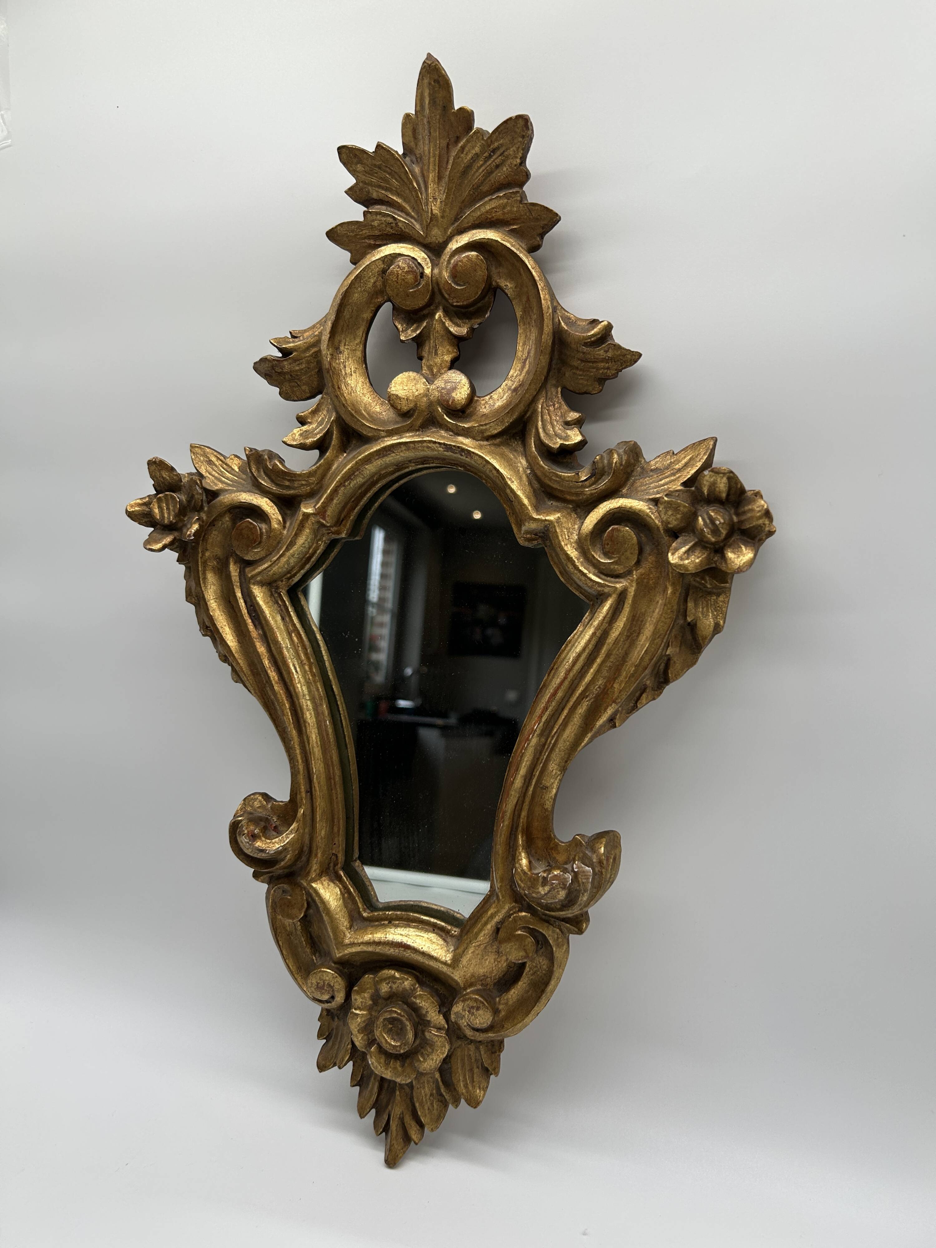 Wooden mirror with gilded stucco