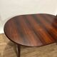 Extendable dining table in Rio rosewood.