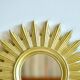 Vintage gold-colored sunburst mirror