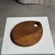 Small circular teak monoxyle cutting board with handle 22 x 13.