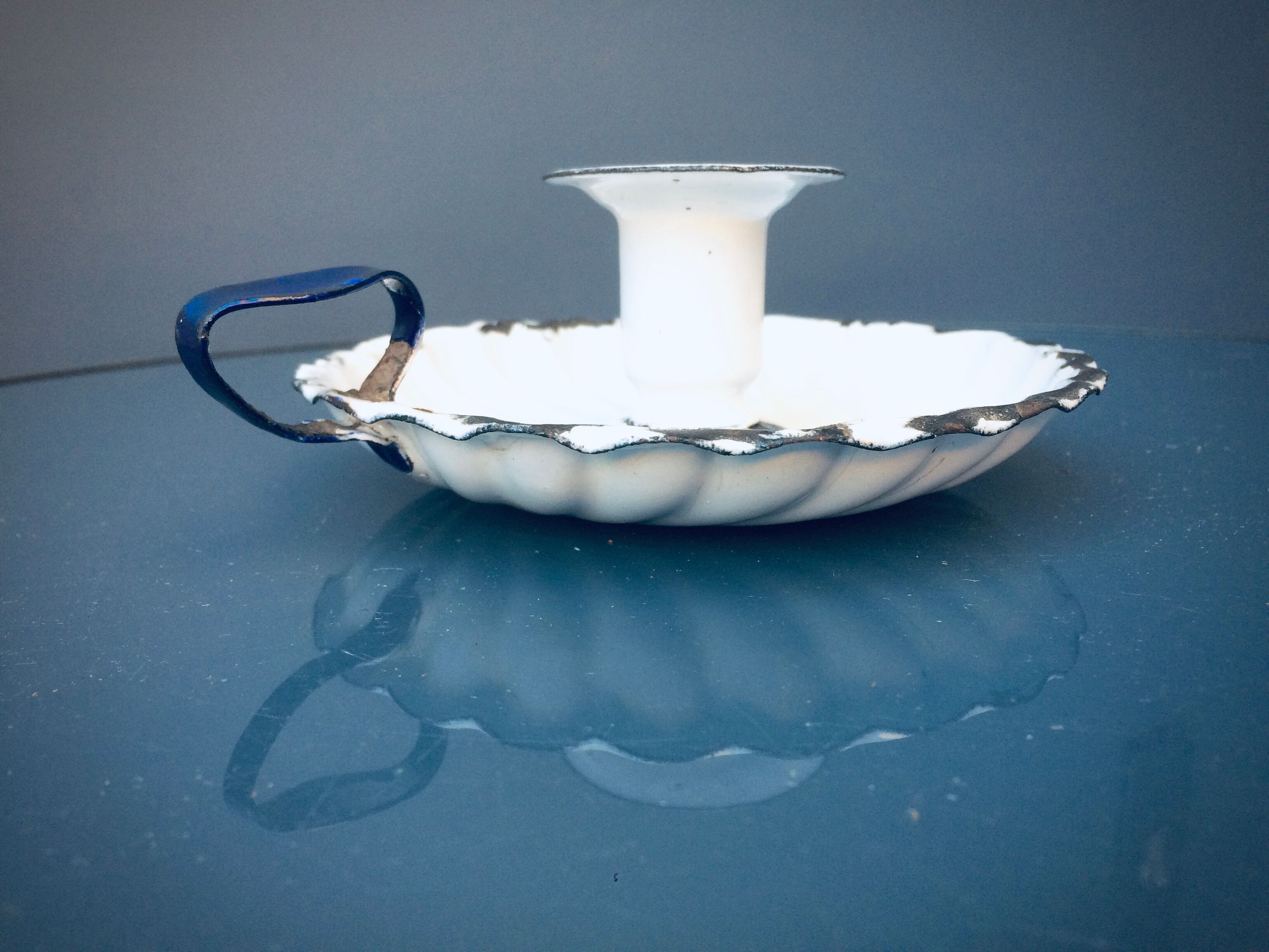 Old white enamelled candlestick