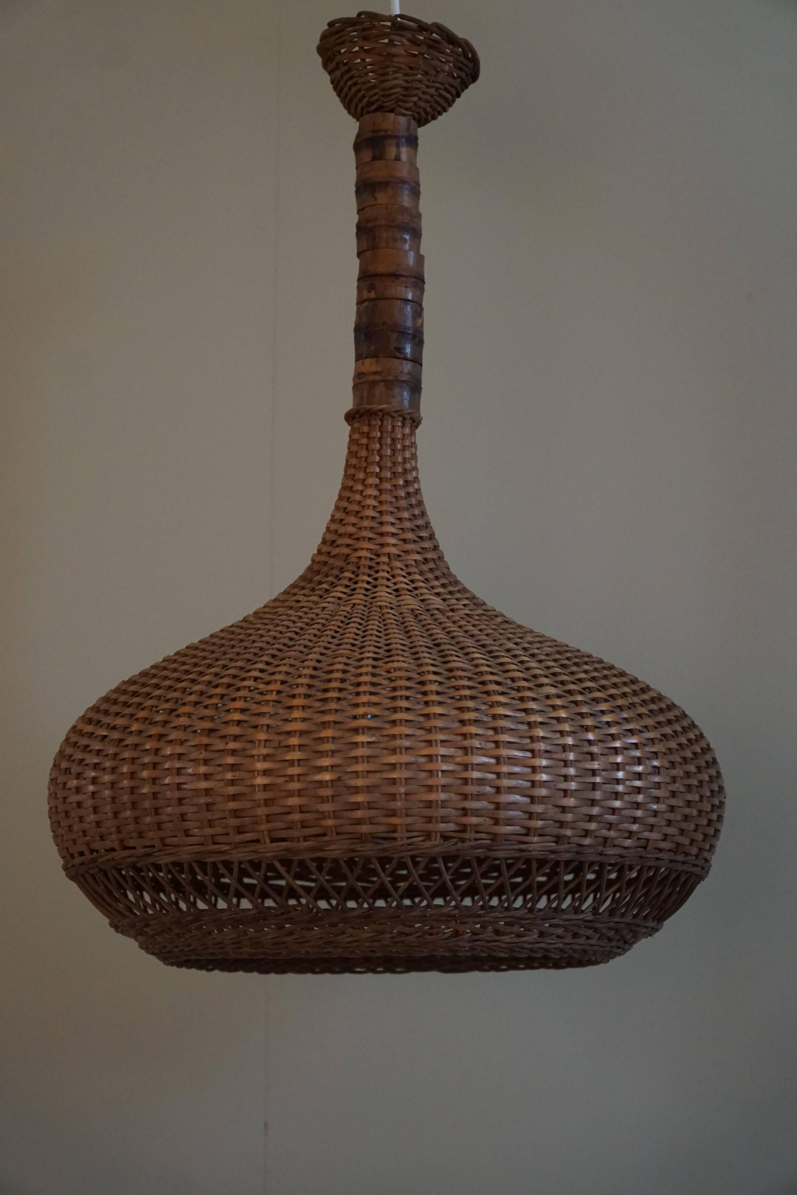 Vintage Danish mid-century rattan pendant light, made in the 1960s.