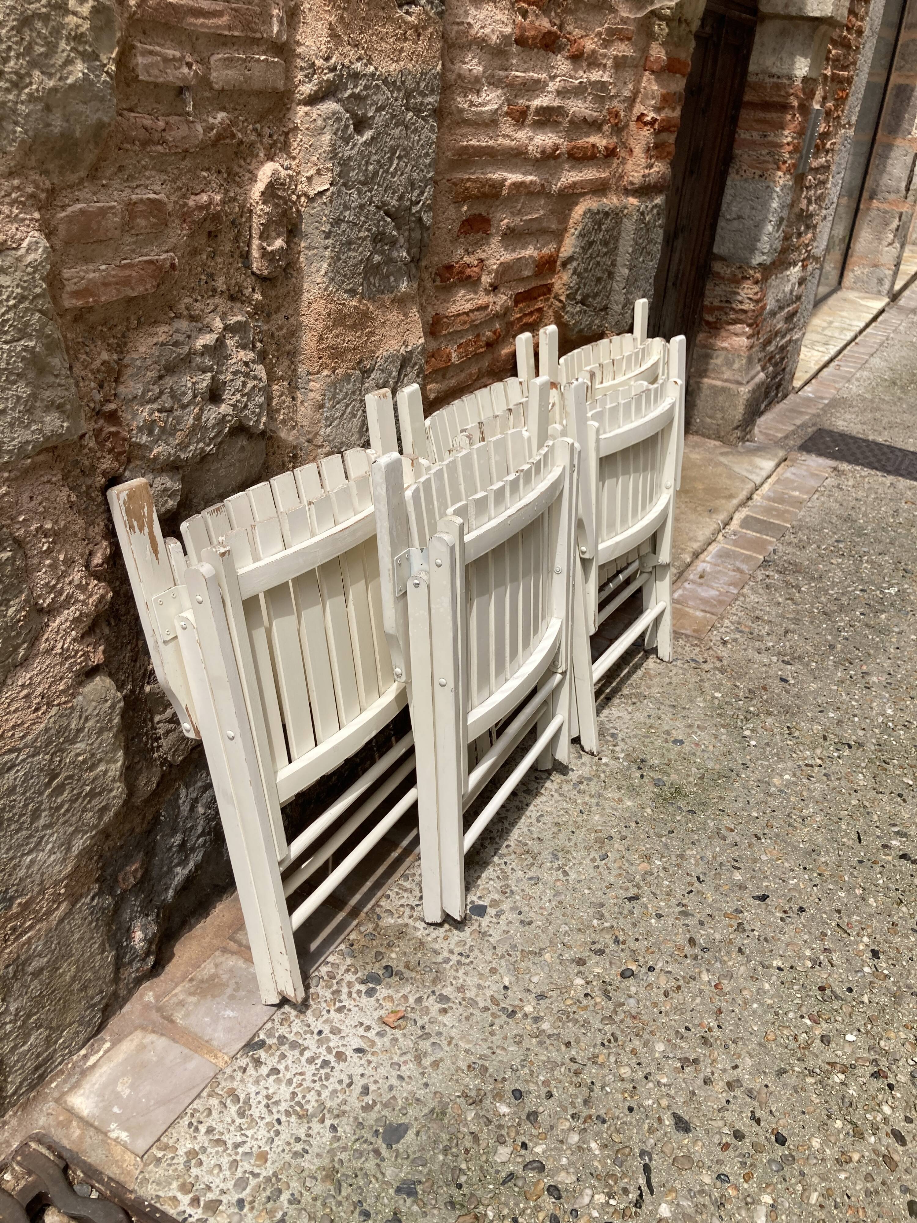 Five wooden garden armchairs