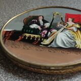 Old round box with decoration fixed under glass