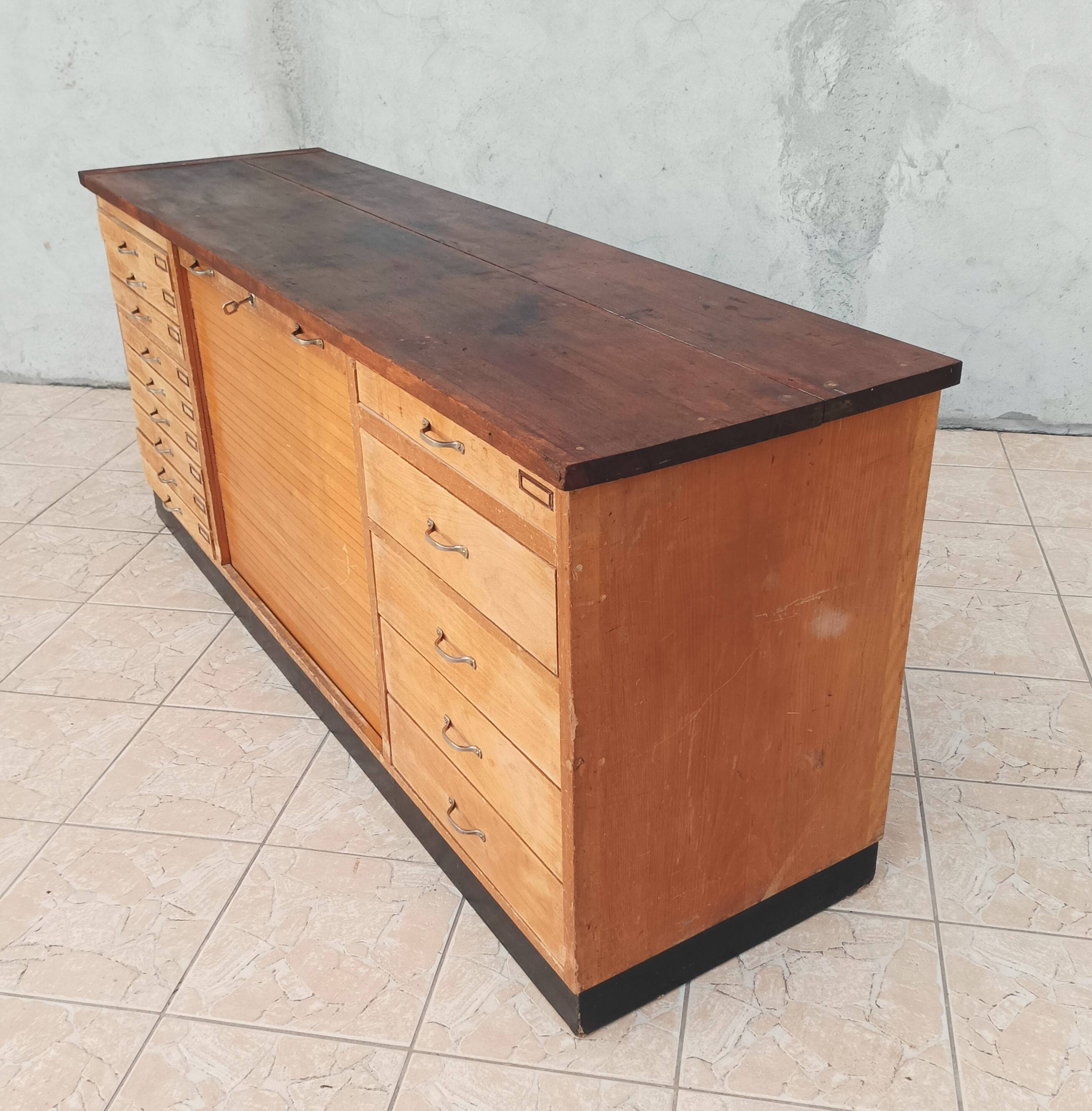 Workshop furniture with drawers and curtain in beech and walnut.