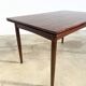 Rosewood dining table with integrated extensions — Denmark, 1960s