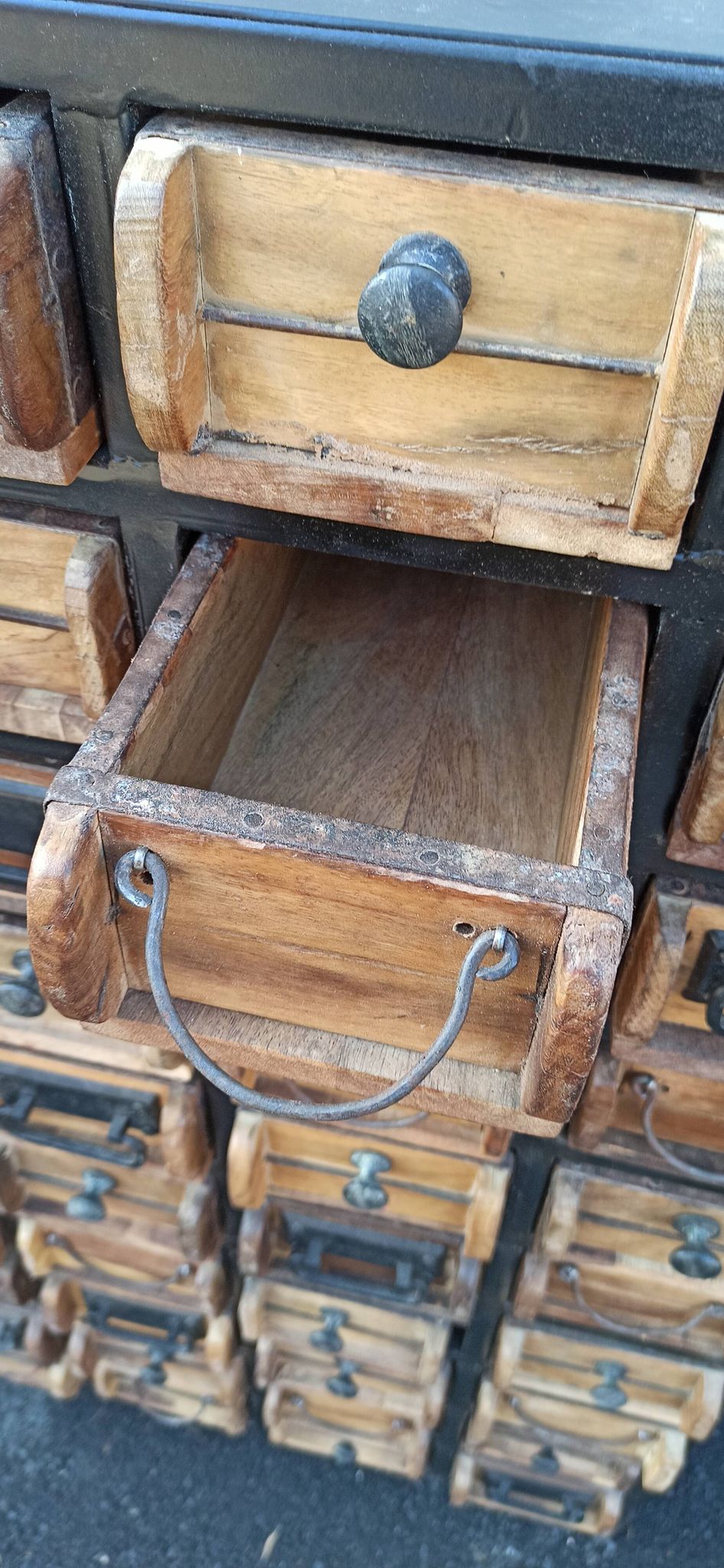 Black metal storage cabinet with 60 wooden drawers