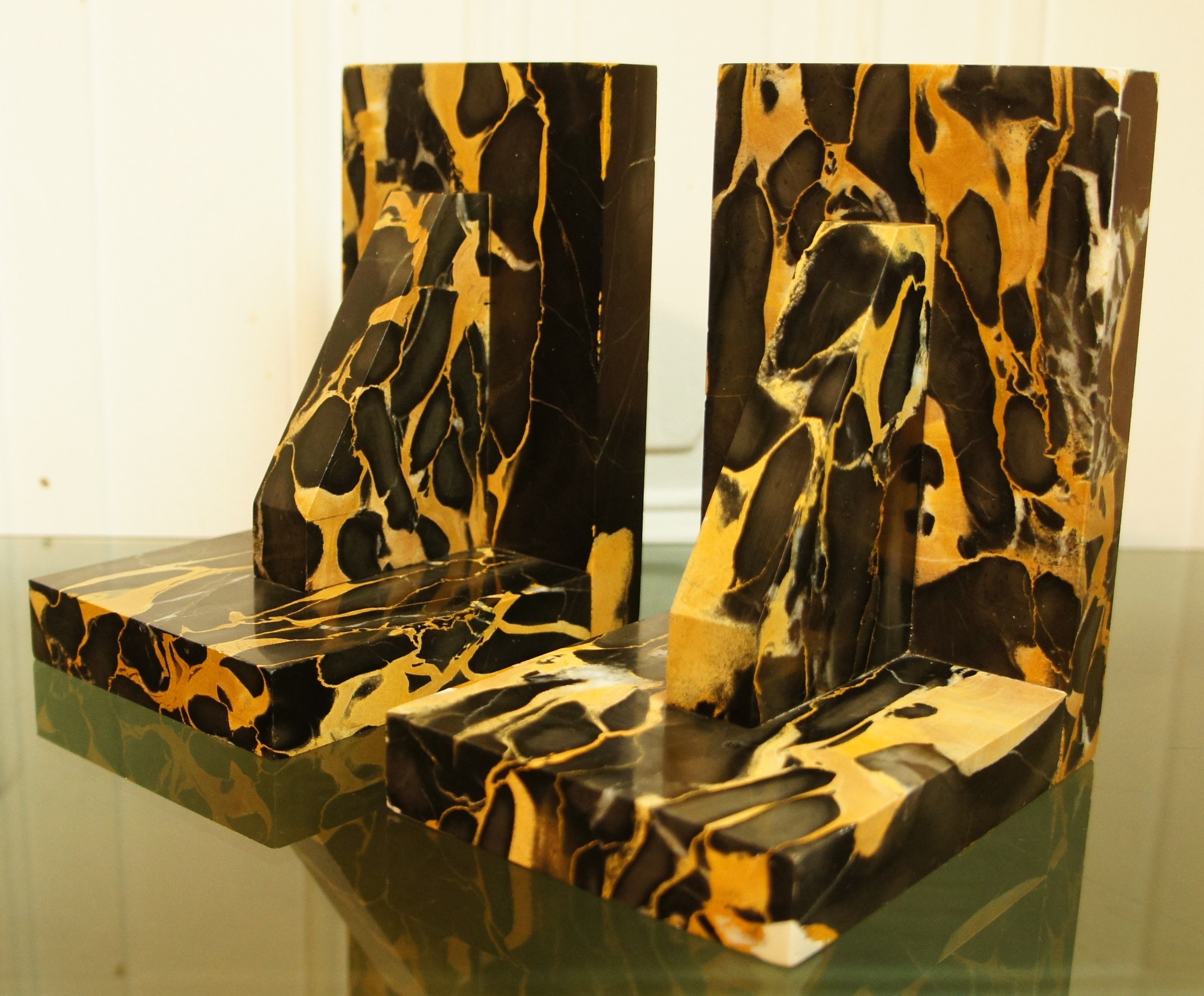 Pair of Portor marble bookends, black and golden yellow