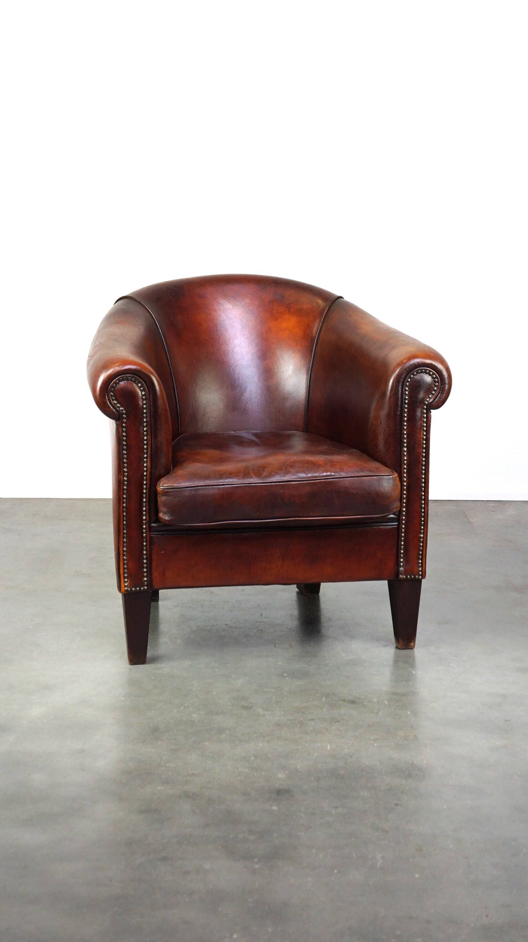 Very luxurious dark brown sheepskin club chair with a more than beautiful patina