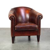 Very luxurious dark brown sheepskin club chair with a more than beautiful patina