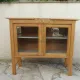 Art Deco sideboard in raw wood with a wax finish, closed by 2 glass doors.