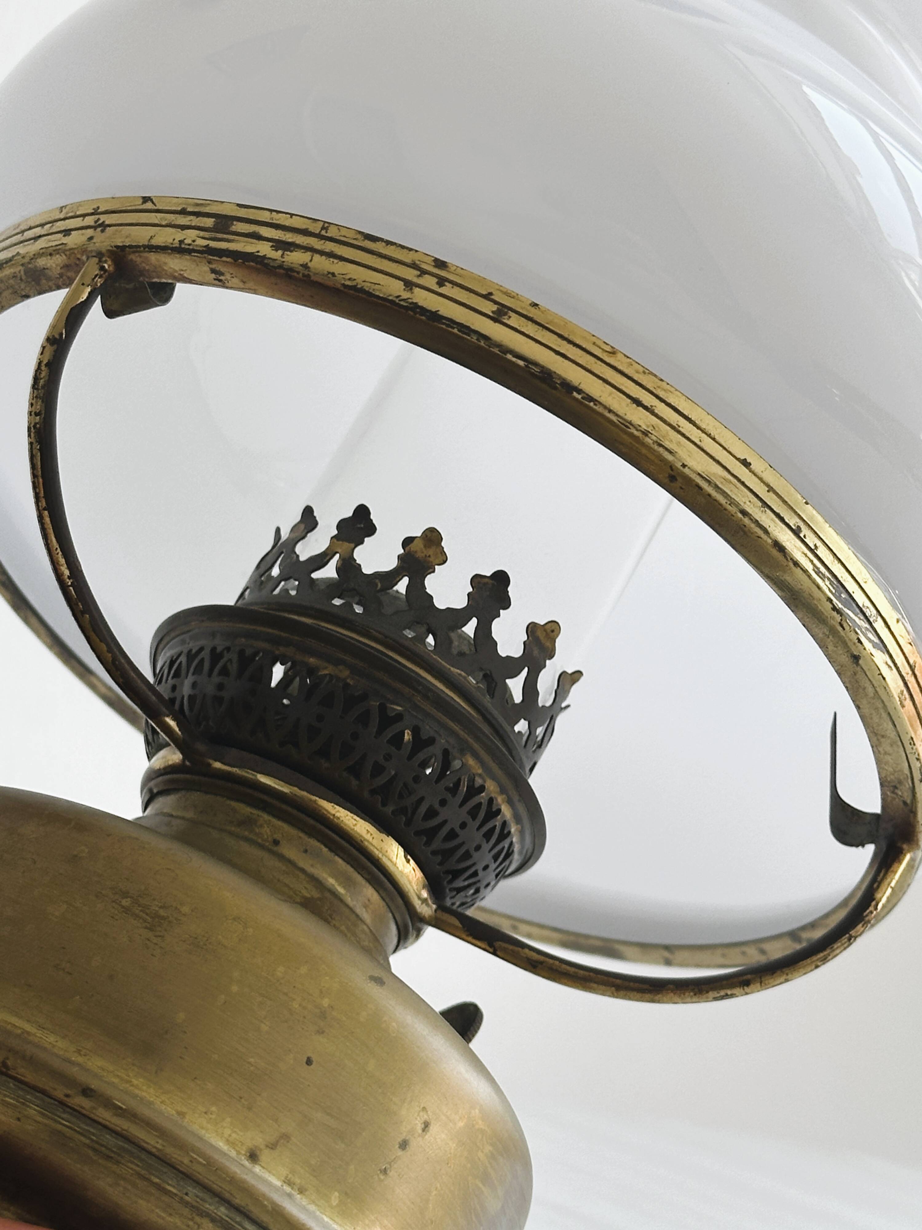 Vintage brass lamp with white opaline glass shade.