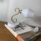 Swan neck wall light in brass with a white glass shade.