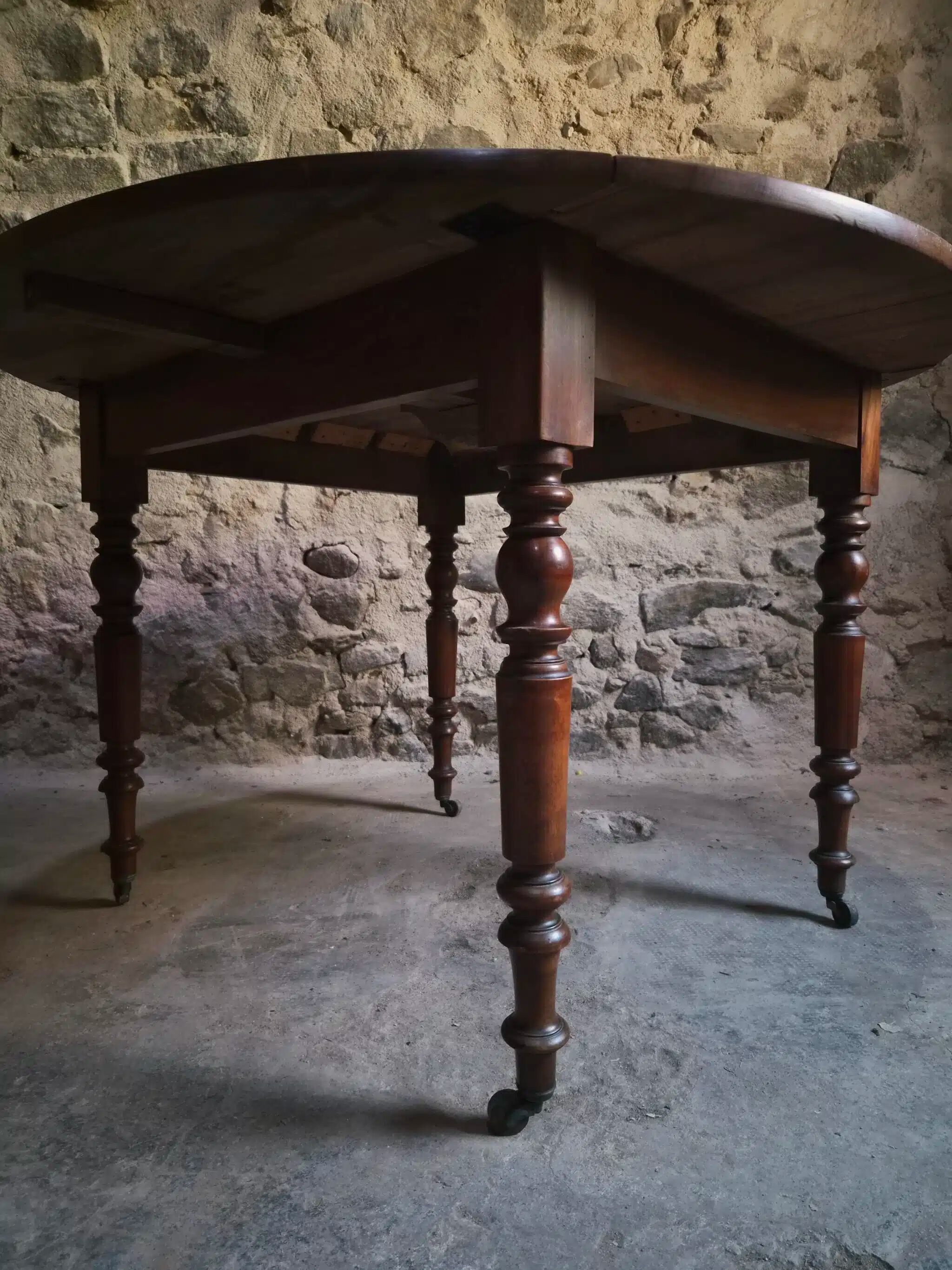 Antique drop-leaf dining table in walnut, France, circa 1900.