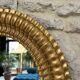 Pair of antique oval mirrors gilded with gold leaf and mercury.