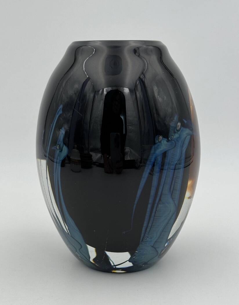 Double-lined blown glass vase with flower inclusions.