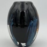 Double-lined blown glass vase with flower inclusions.