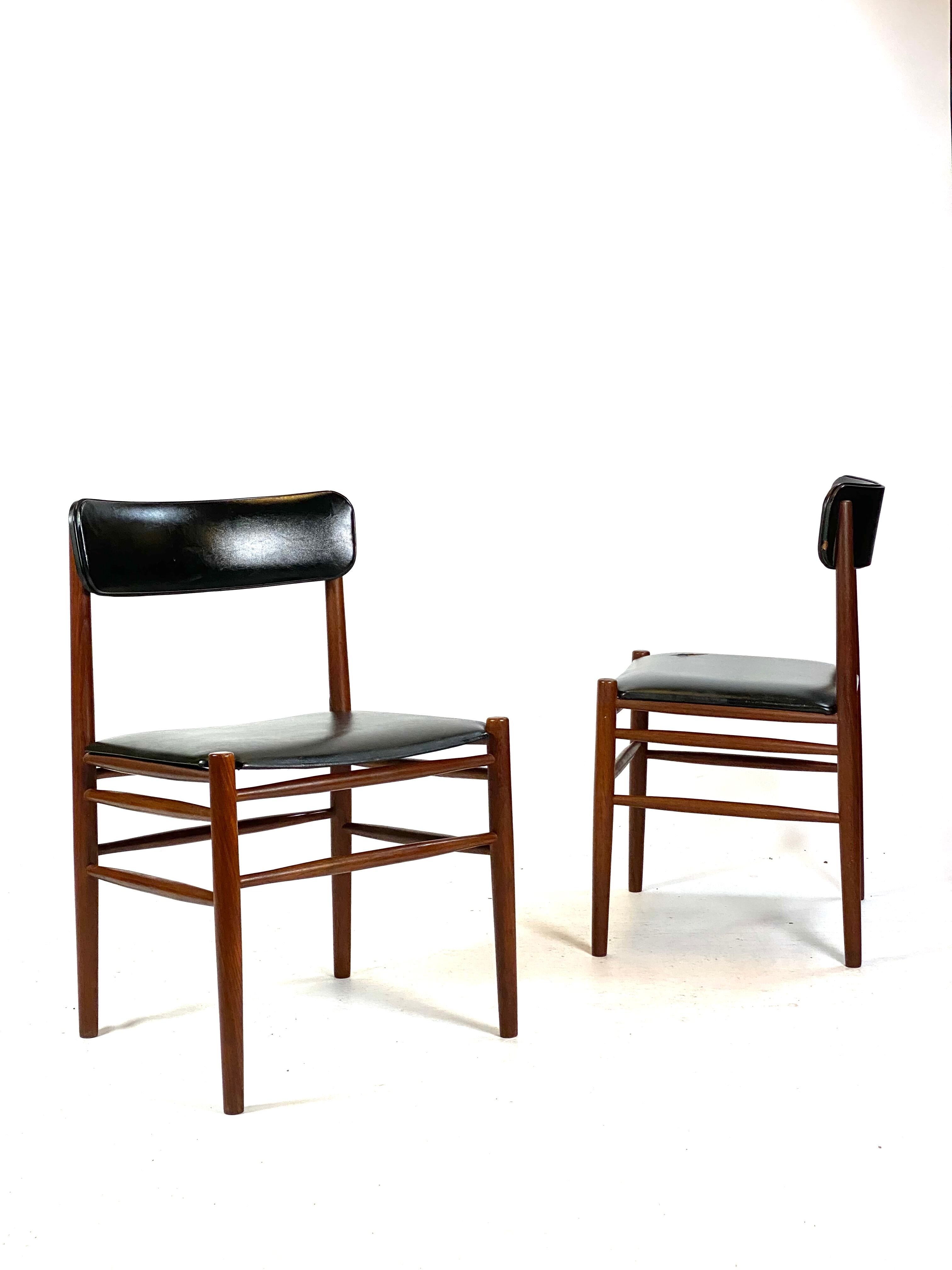 Two dining room chairs in teak and upholstered with black leather of Danish design, 1960s