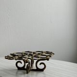 Brass trivet with openwork pattern in the shape of apples.