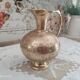 Chiseled brass pitcher decorated foliage