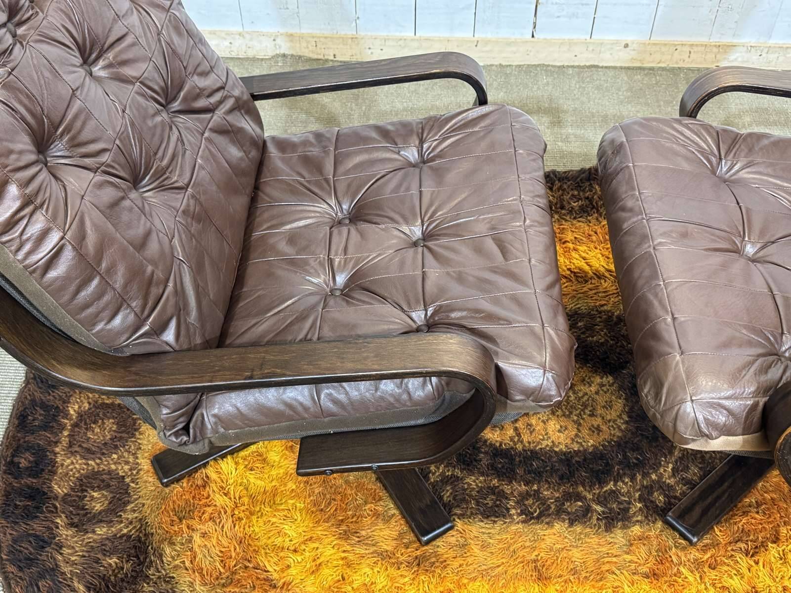 Pair of Norwegian swivel armchairs in leather and beech from the 1970s.