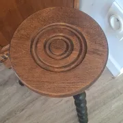 Brown and black wooden tripod stool