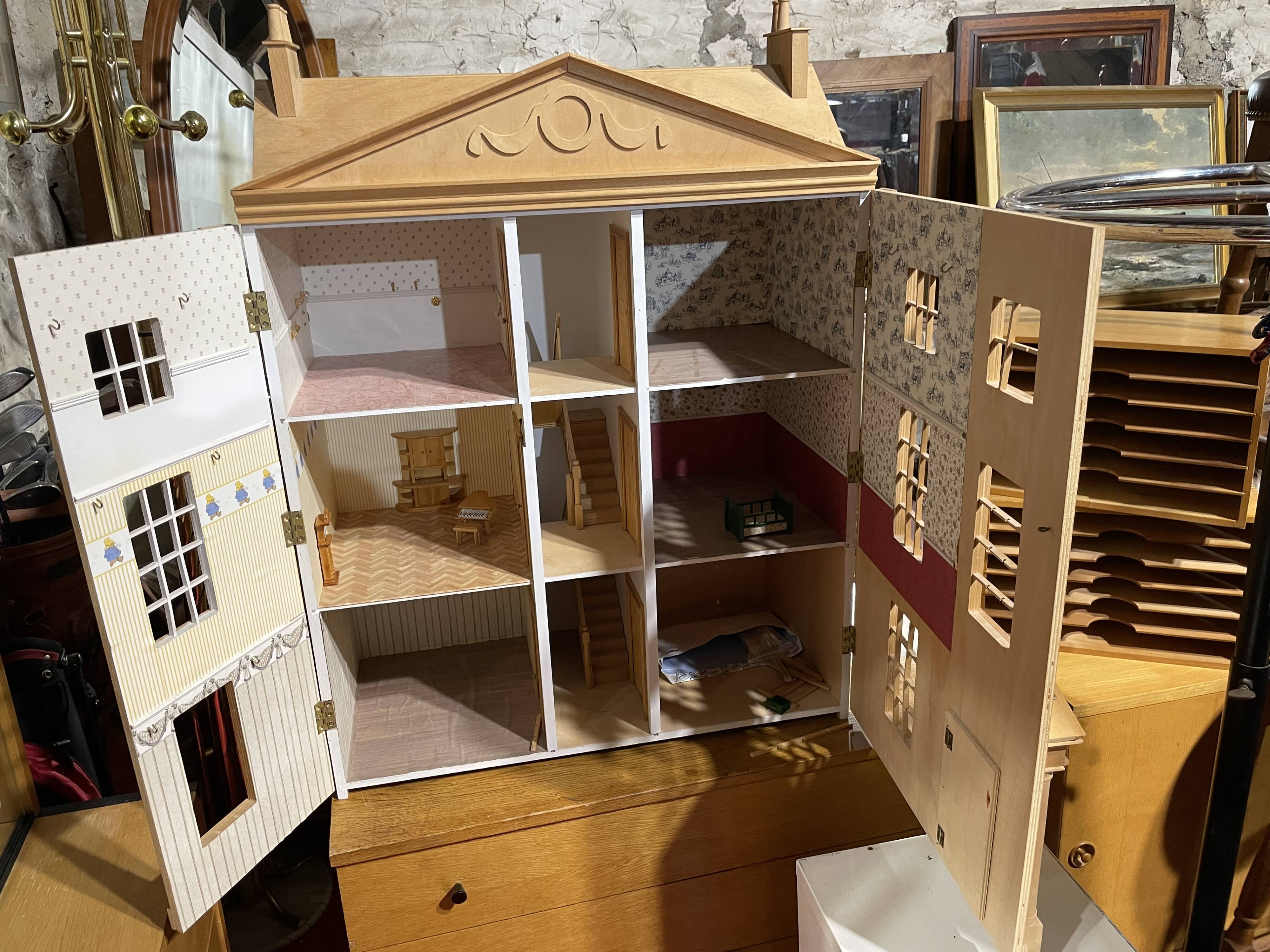 Large wooden dollhouse with miniature furniture