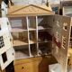 Large wooden dollhouse with miniature furniture