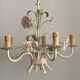 Five-branch enamelled metal chandelier with pink flower decoration.