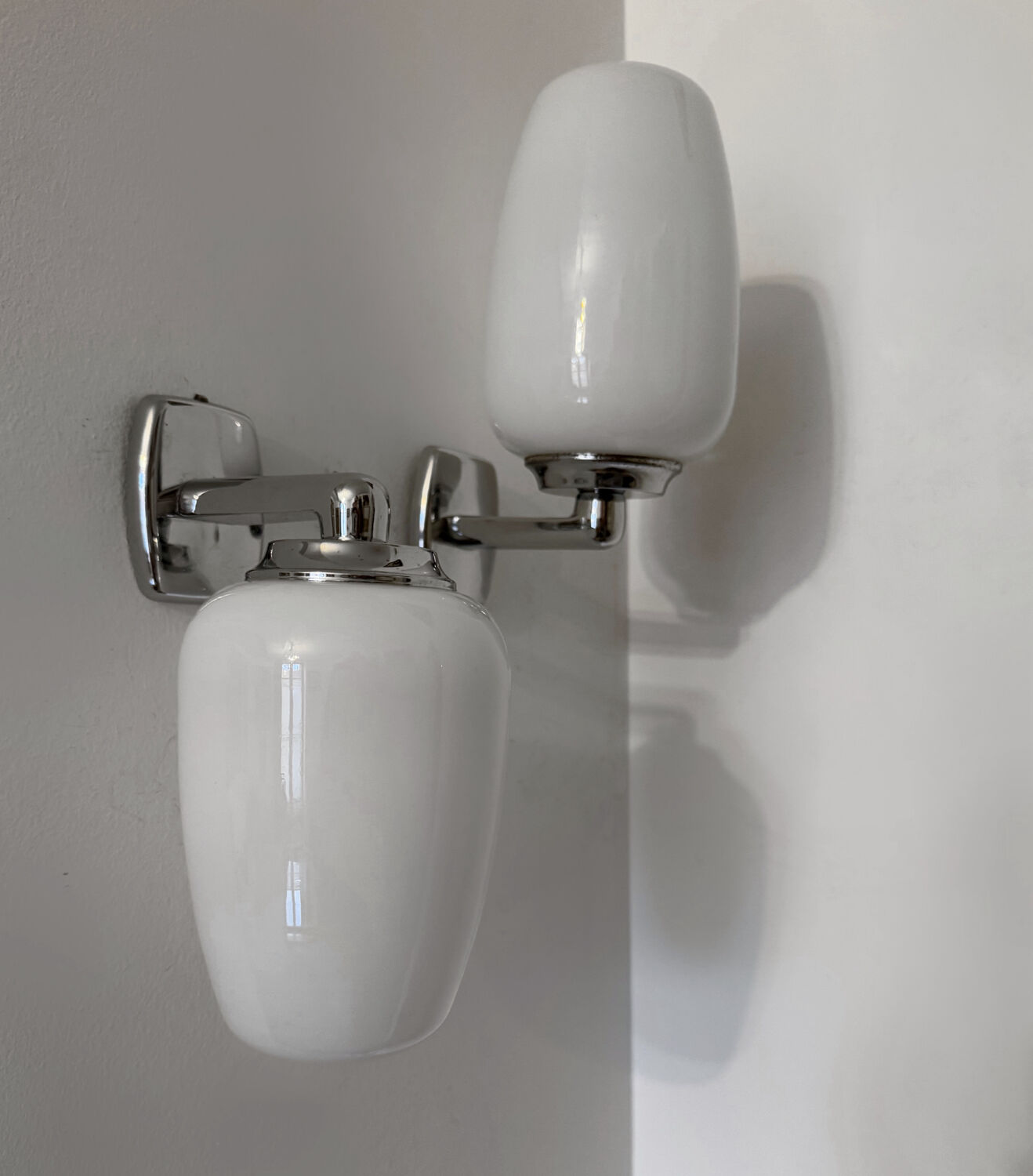 Chrome and opaline wall lights from the 70s.