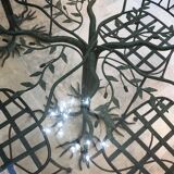 Wrought iron table with tree sculpture and glass top
