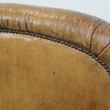 Fauteuil ancien en cuir de mouton