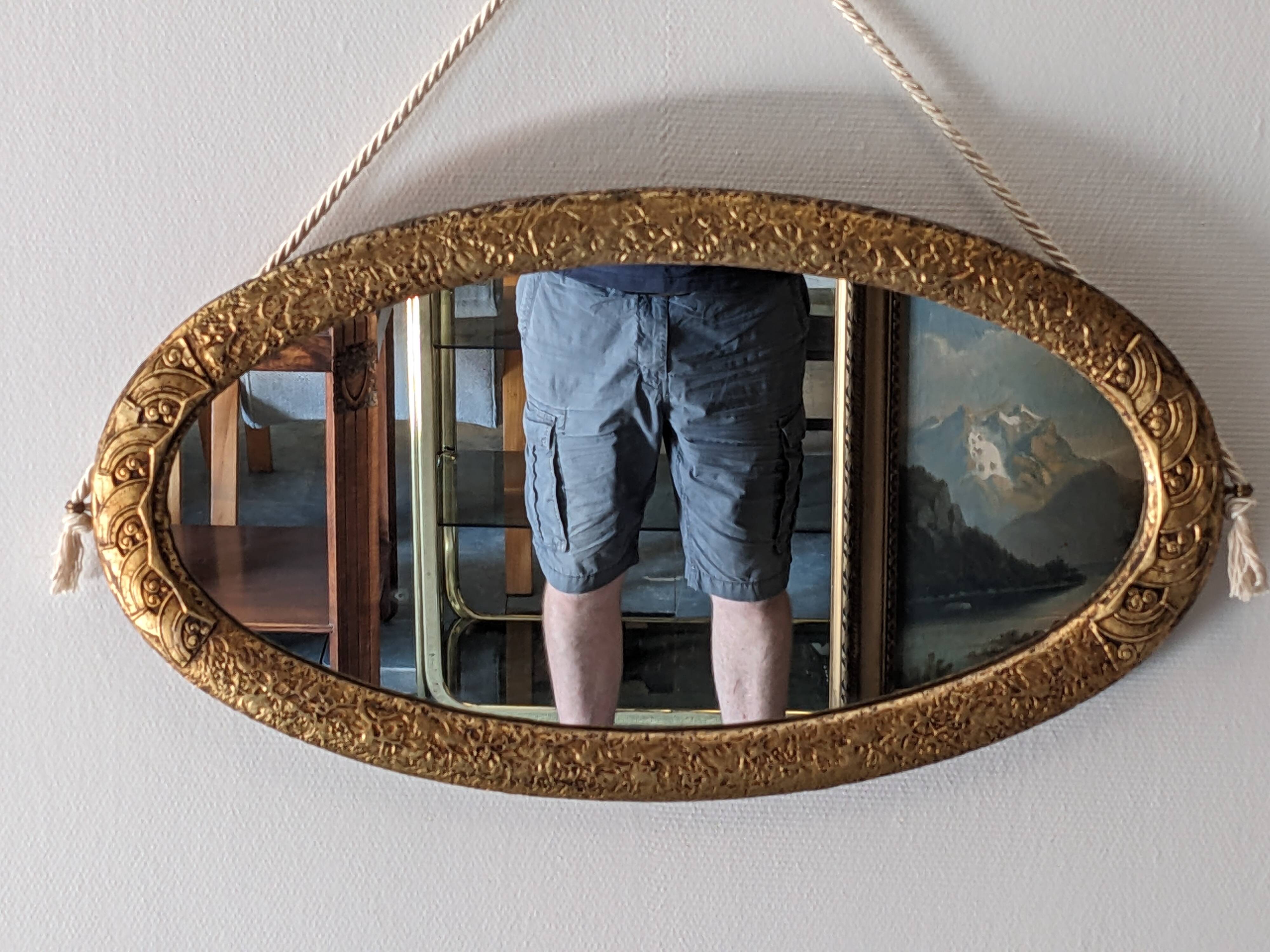 Art Deco oval mirror in gilded wood, France circa 1920