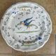 Hollow plate in Moustiers faience decorated with a bird, 19th century.