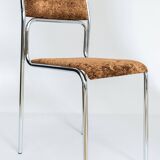 Chrome dining chair upholstered in brown bitten velvet.
