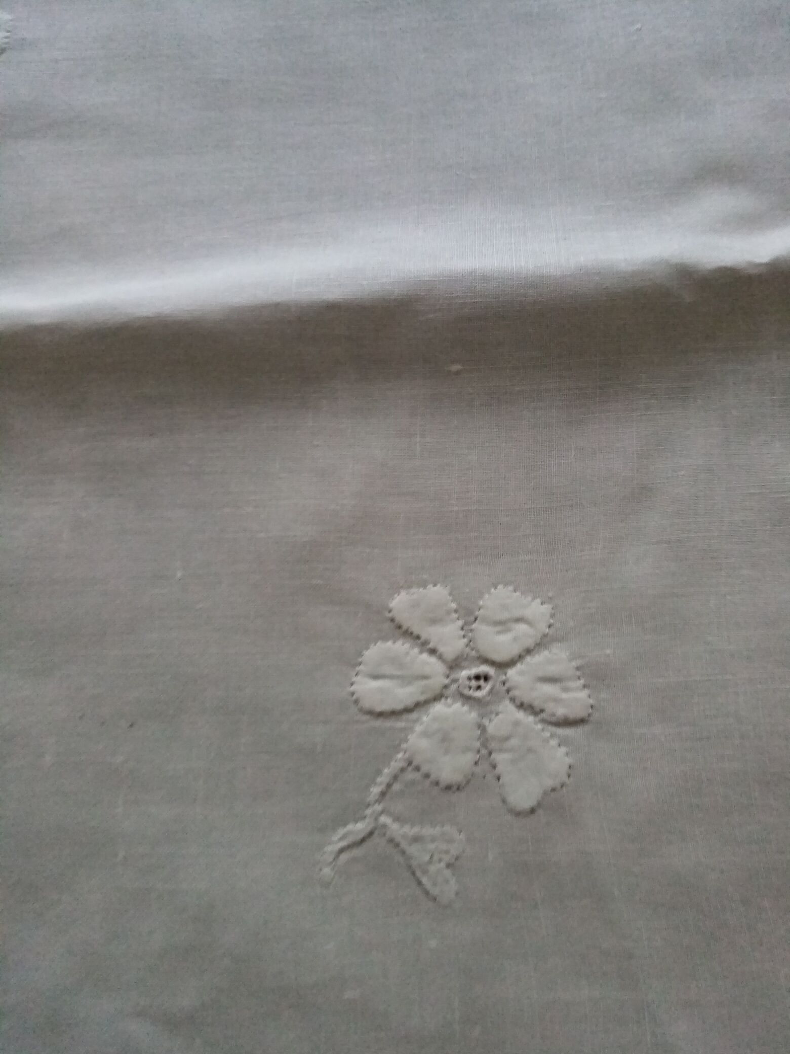 Antique white tablecloth embroidered with flowers and matching napkins