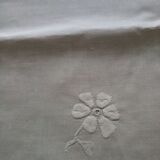 Antique white tablecloth embroidered with flowers and matching napkins