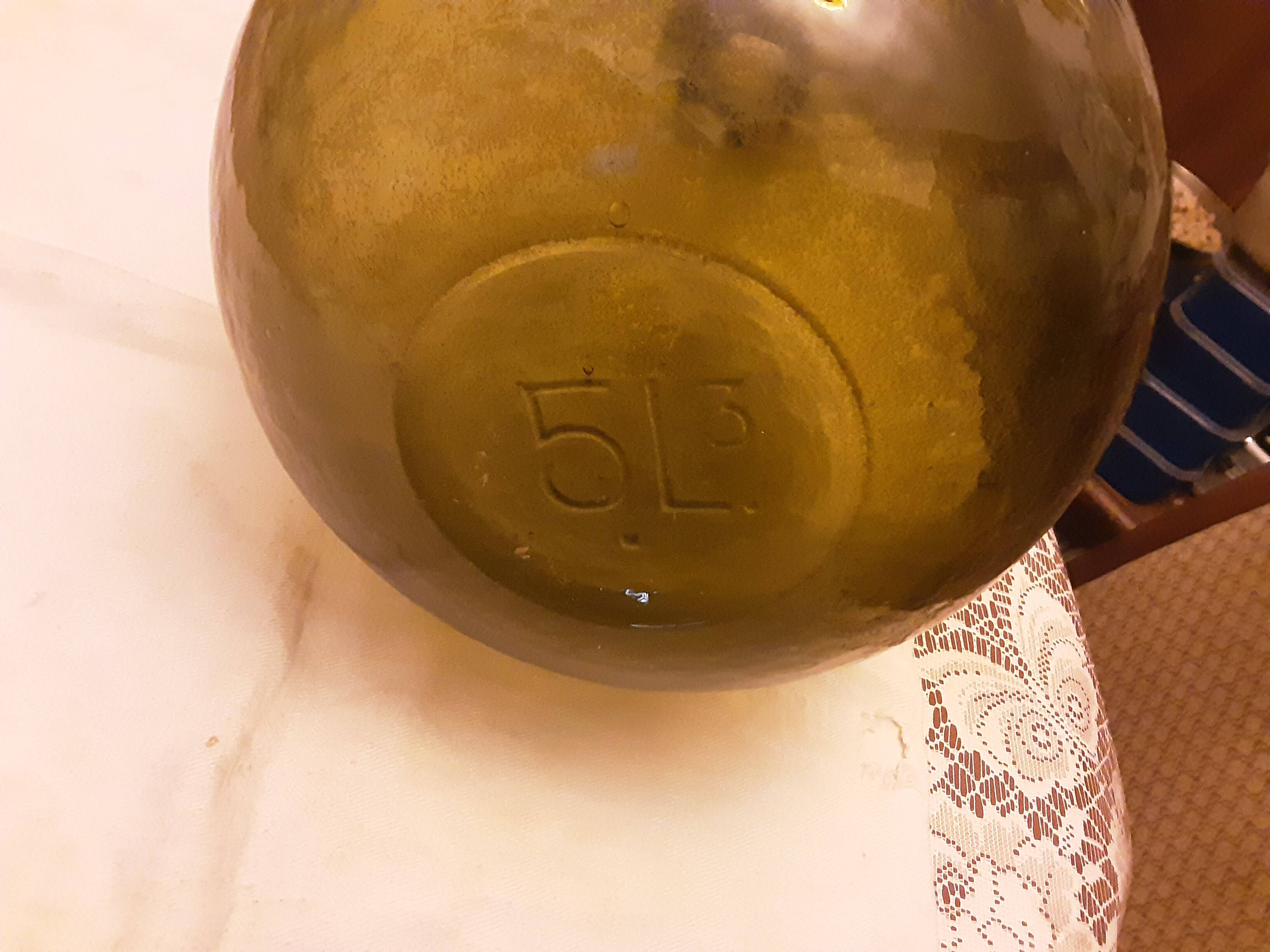 Old green glass demijeanne