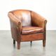 Vintage sheepskin club armchair finished with black piping